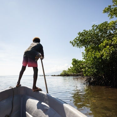 Boy on a boat in the mangroves near the village of Walande.