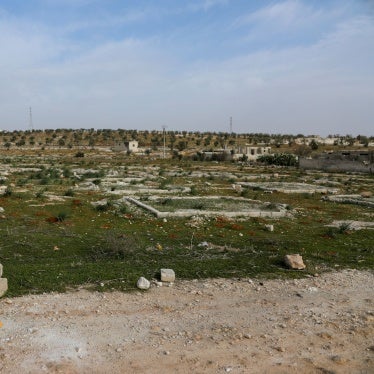 Nidal Ahmad stands near his olive farm in Aleppo, Syria on March 4, 2025. Its location near a former Syrian Army military camp has prevented him from harvesting crops for years. Last December, Nidal returned to check on his land and lost his foot in a landmine explosion. 