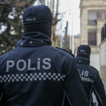 Police outside the building of Toplum TV, independent online media outlet, where law enforcement searched the offices and detained journalists, in Baku, Azerbaijan, March 6, 2024.