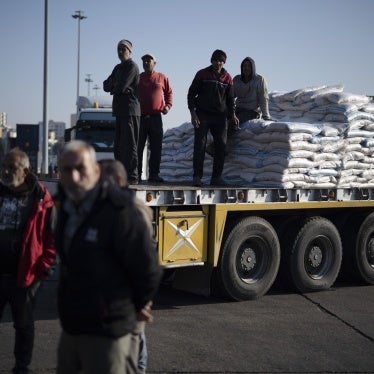 Syrian port workers move on a truck carrying goods at the port of Latakia, Syria, December 17, 2024. 
