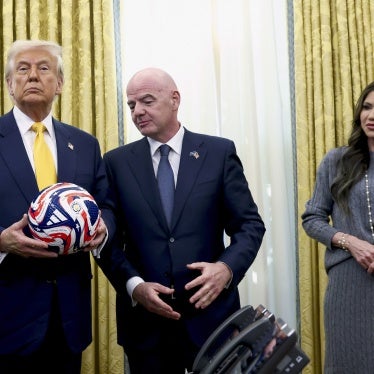 US President Donald Trump (L), with FIFA President Gianni Infantino (C) and Homeland Security Secretary Kristi Noem watch in the Oval Office of the White House in Washington, DC, March 7, 2025.