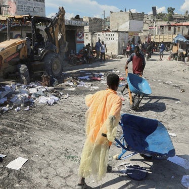 Haiti young people carrying debris