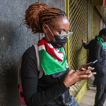A protestor checks her phone during the youth-led protests against proposed tax hikes in Kenya's finance bill 2024/2025.