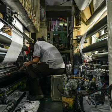 A worker inspects a machine processing color for plastic products at a factory in Malaysia, October 9, 2024.