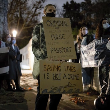 Protesters hold placards in solidarity with humanitarians who were still detained in Greece, November 18, 2021.