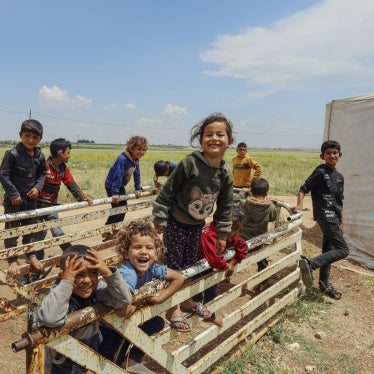 Displaced Syrian children laugh and play among temporary tents set up after the fall of the Bashar al-Assad government near Idlib, Syria, May 15, 2025.