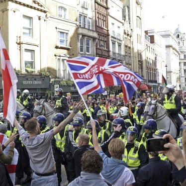 People opposing the housing of asylum seekers (front) confront anti-racism group members (back) with police officers forming a line between them in London, UK, on September 13, 2025. 
