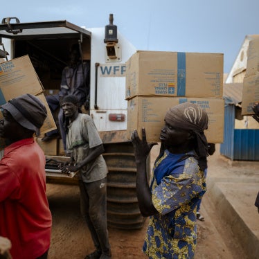 Workers load food onto all-terrain vehicles at a World Food Programme 