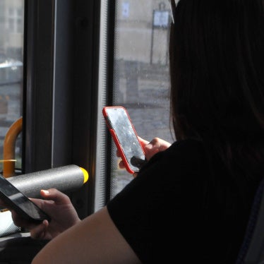 People using their cellphones while in transit, September 2023.