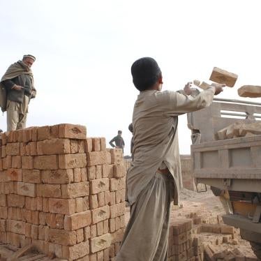 Hazrat Hussain, 10, loads bricks onto a truck. Hazrat doesn’t go to school and works alongside his two teenage brothers at a brick kiln outside Kabul.  