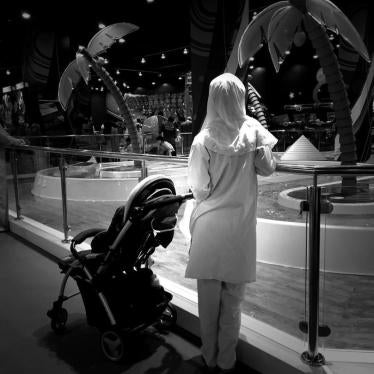 A migrant domestic worker watches over a child playing in the Magic Planet, City Centre Muscat, a shopping mall in Oman. 