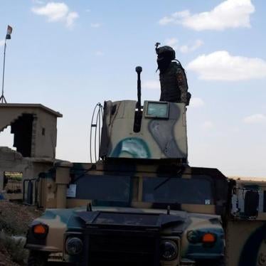 A member of Iraqi security forces stands on the turret of an armoured vehicle along a highway near west of Mosul, Iraq, June 22, 2017. 