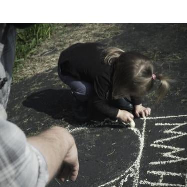 A father plays with his daughter, who was born with atypical sex characteristics. Despite pressure from doctors, the parents chose not to elect medically unnecessary surgeries on their child. 