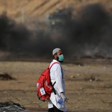 A medic looks on during a demonstration near the separation fence with Israel in southern Gaza, May 18, 2018.