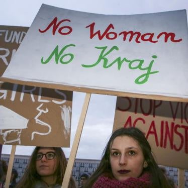 Women’s rights supporters at a demonstration for International Women’s Day in Krakow, Poland, on March 8, 2018. The center sign uses the slogan “No Woman, No Country.”