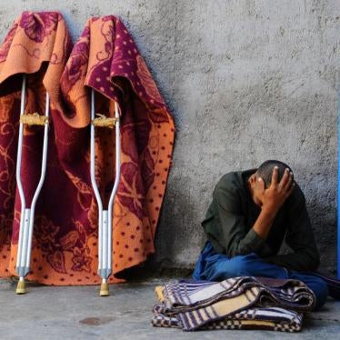 A man sits in the yard at a mental health facility in the city of Herat, April 2014. © 2014 Aref Karimi/AFP/Getty Images