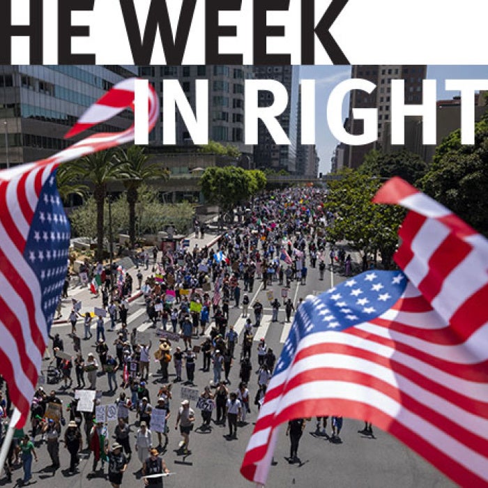 American flags fly over procession. 
